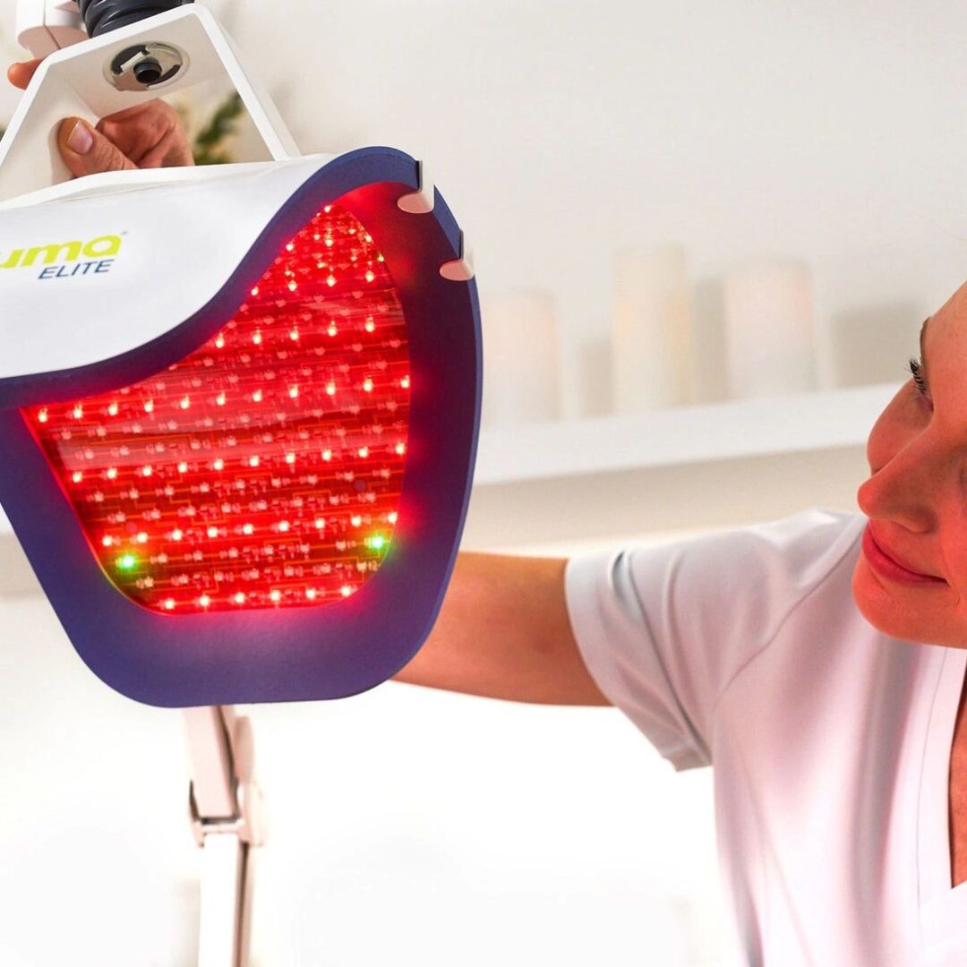 Woman using red light therapy device.